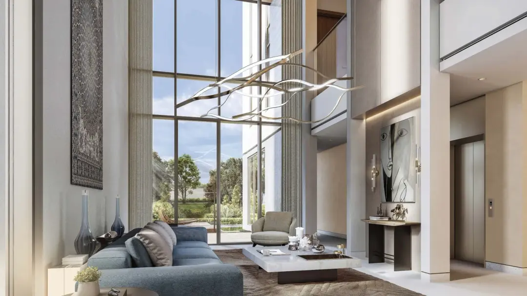 The Orchard Estate Villas at Sobha City Abu Dhabi — interior render of a double-height living and dining space with sculptural light fixture and floor-to-ceiling windows. Artist's impression. Indicative only.