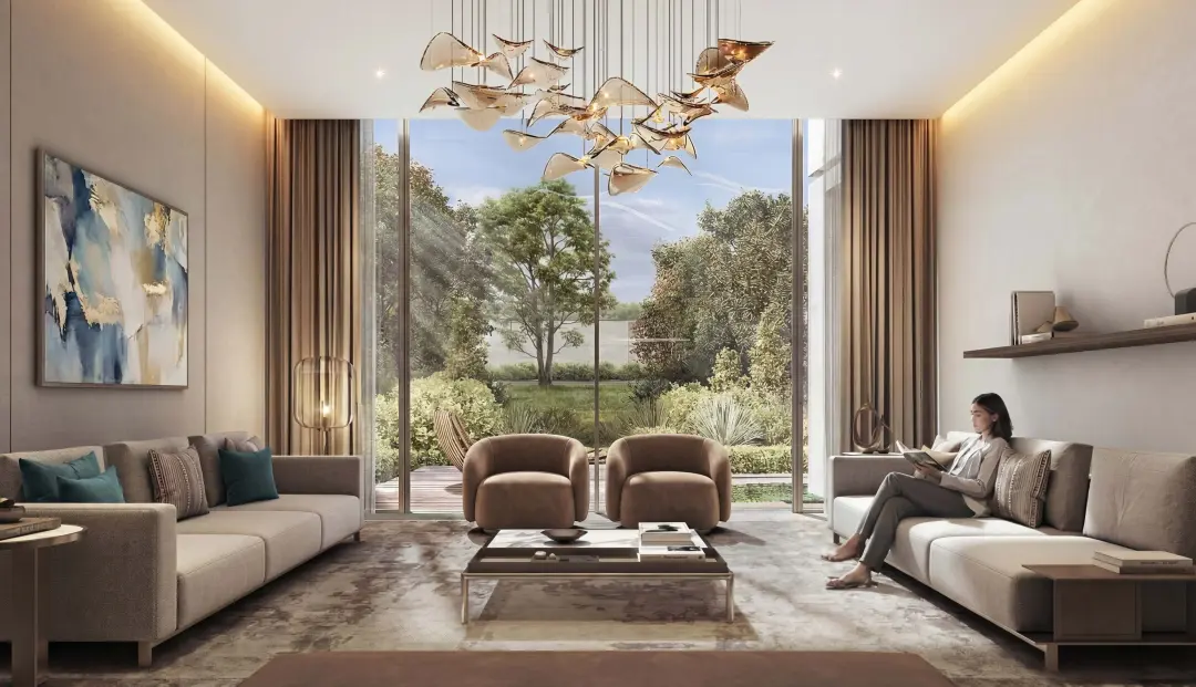 The Terraces Garden Villas at Sobha City Abu Dhabi — interior of a double-height living room with sculptural pendant chandelier and views to a landscaped garden. Artist's impression. Indicative only.